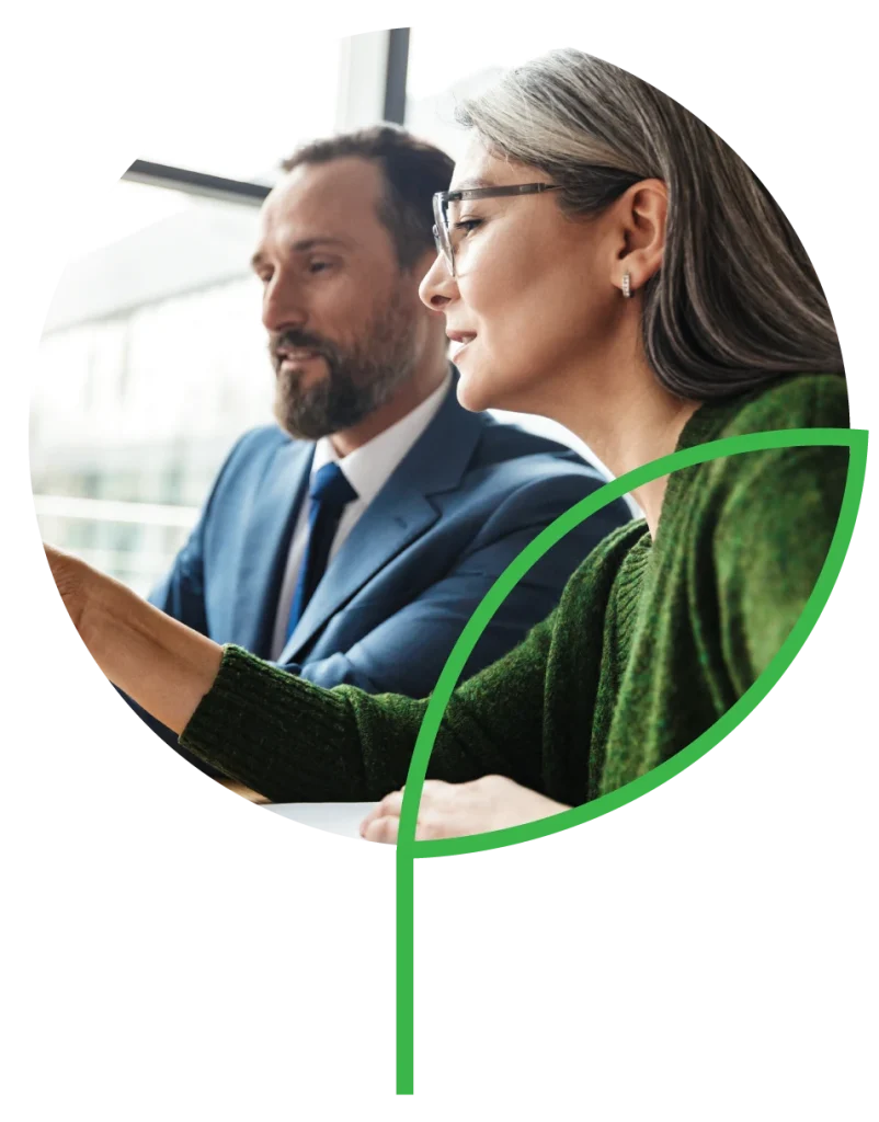 Photo of colleagues talking while working with laptop and documents