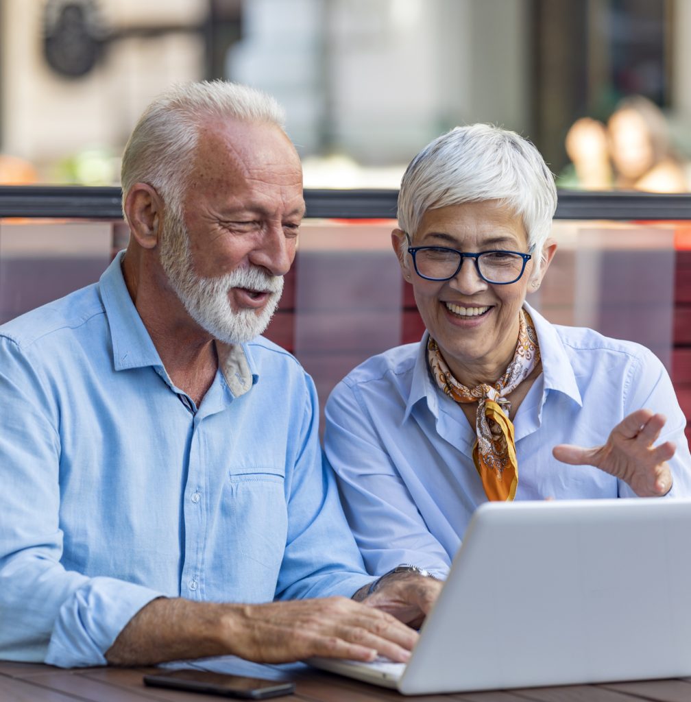 Senior Business Couple is Sitting at the Table in Restaurant and Discussing About the Business. Two Older Colleagues is Analyzing Business in the Coffee Shop on Their Laptop.